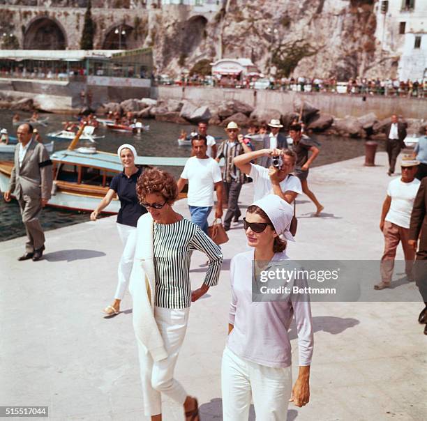 Mrs. Jacqueline Kennedy and Mrs. Agnelli on a pier in Amalfi before embarking on the yacht Agneta.