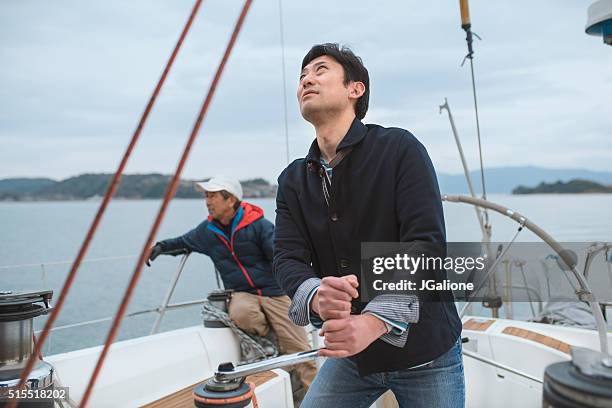 two men on a yacht - father son sailing stock pictures, royalty-free photos & images