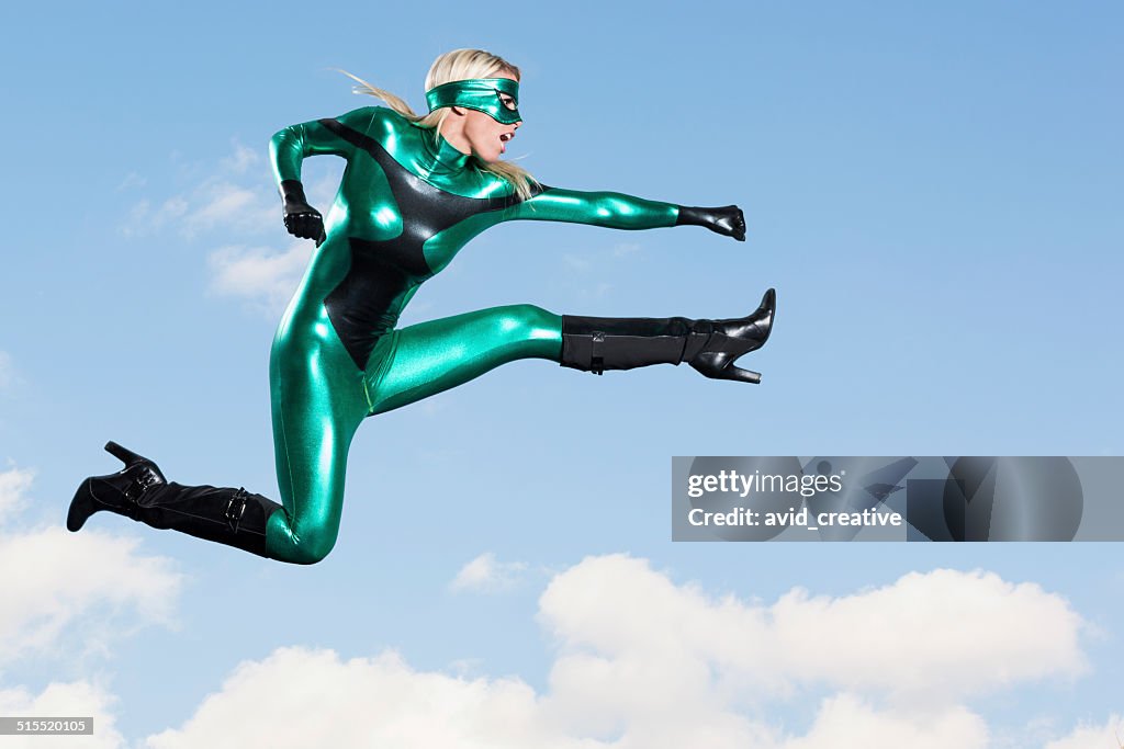 Jumping: Female Super Hero Flying Punch Kick