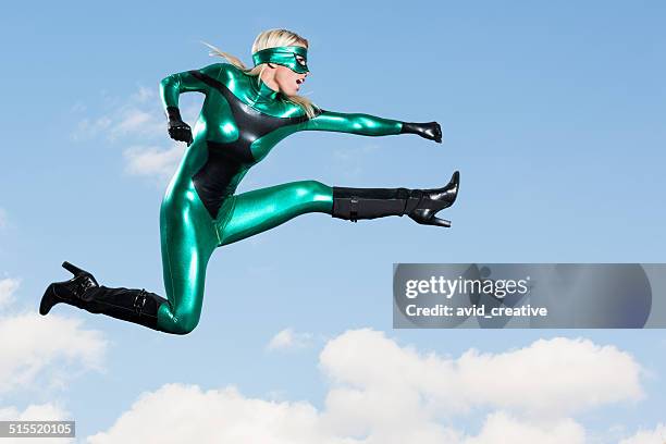 jumping: female super hero flying punch kick - fight or flight stock pictures, royalty-free photos & images