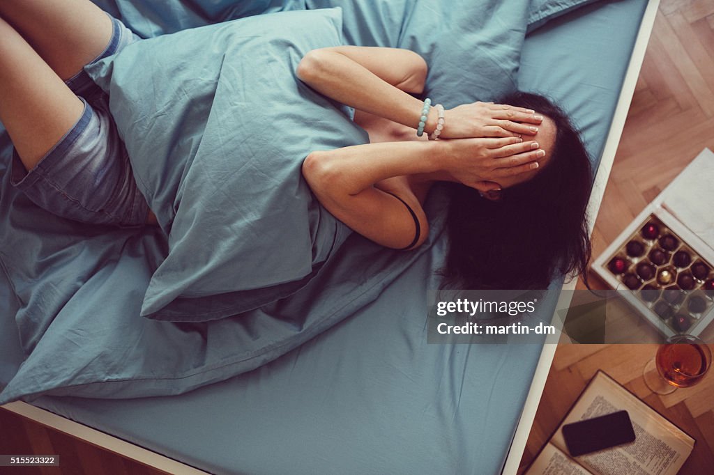 Girl crying in bed