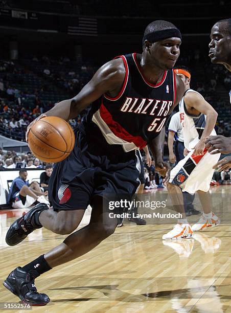 Zach Randolph of the Portland Trailblazers goes around Emeka Okafor of the Charlotte Bobcats October 22, 2004 at the Charlotte Coliseum in Charlotte,...