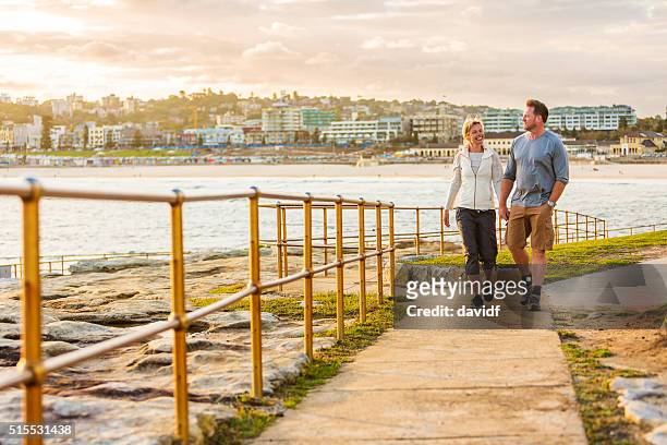 happy middle aged active fit healthy beach couple walking outdoors - australian people stock pictures, royalty-free photos & images
