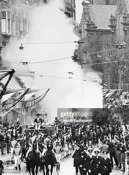 Smoke bomb explodes behind the coach carrying Princess Beatrix and her groom, German diplomat Claus Von Amsberg, during their wedding procession in...