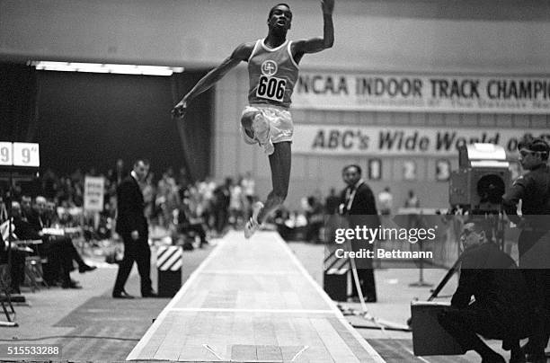 Obviously Olympic material, Bob Beamon, sophomore at the University of Texas, strives for distance in the inaugural triple jump event of the NCAA...