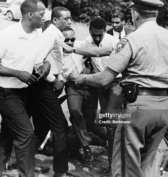 As they attempt to take up James Meredith's march at the point where Meredith was hot, civil rights leaders Floyd McKissick, Dr. Martin Luther King,...