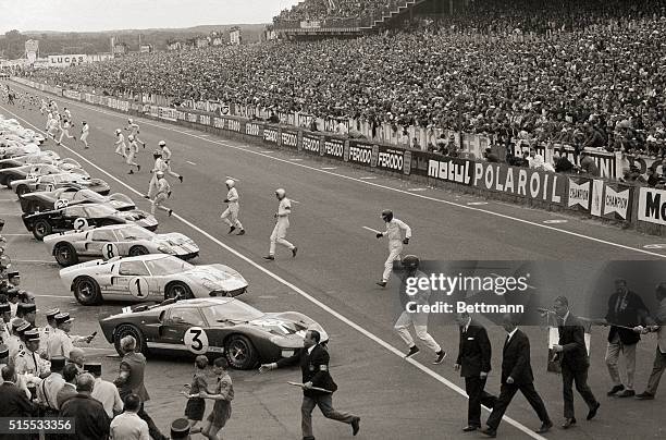 Drivers run to their cars at the start of the 24 Hours of Le Mans race, at the Circuit de la Sarthe, in Le Mans, France, 18th June 1966. The four...