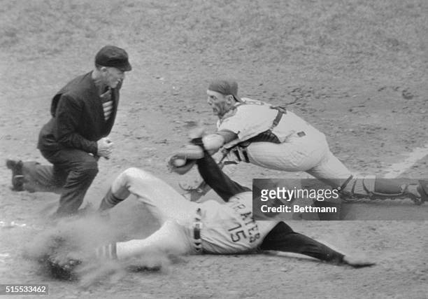 Pittsburgh Pirates' Manny Mota slides into home plate but is called out by umpire Shag Crawford, as Chicago Cubs' catcher Randy Hundley puts the tag...