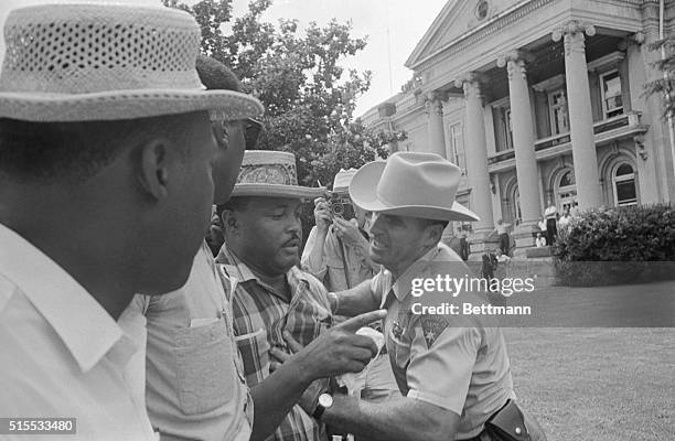 Keeping Negroes off the grass, Le Flore Co. Deputy Sheriff pushed Hosea Williams on chest as he trys to prevent Mississippi freedom marchers from...