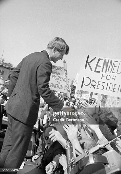 Governor Edmund G. Brown, , points the way for Senator Robert F. Kennedy, , as they arrived at Fair Grounds where the New York Democratic campaigned...