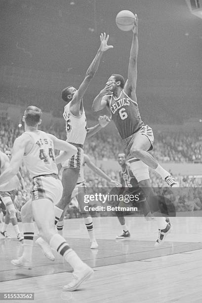 Boston Celtics Bill Russell goes up for a shot at the hoop only to find Los Angeles Laker LeRoy Ellis on his way up to block the shot. Los Angeles...