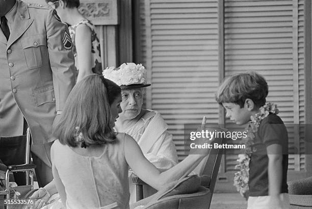 John John Kennedy became restless while watching the Kamehameha day parade in Honolulu June 11th, and his mother, Jackie, wasted no time in pointing...