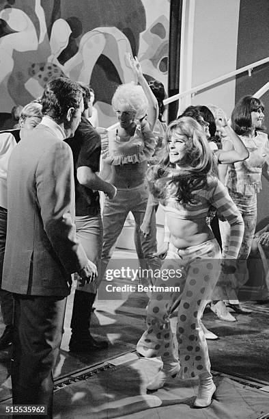 Actress Ann Margret provides the excitement as she goes wild in a dance sequence with Dean Martin in their newest Columbia Picture, "Murder's Row"....