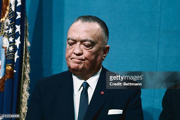 Edgar Hoover listens to President Johnson's speech, which launched the government on a long term drive to wipe out organized crime and its "guerrilla...