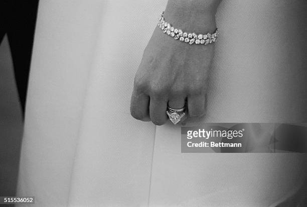 Nine carat diamond engagement ring and an old fashioned plain gold wedding band are conspicuous on the hand of the new Mrs. Frank Sinatra--the former...