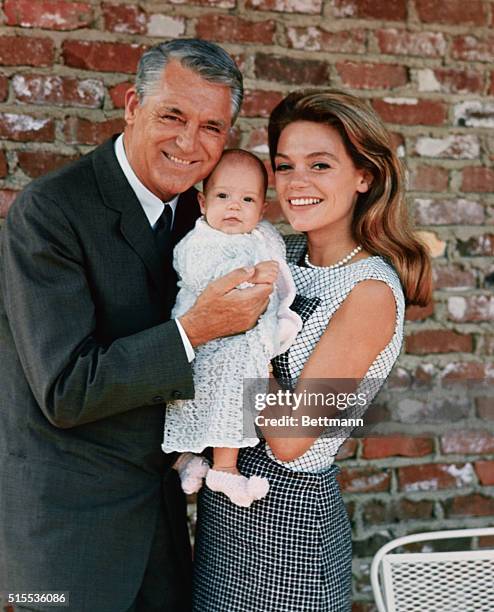 Jennifer Grant, 3 1/2-months-old, wears a big smile for the cameraman as she makes her debut with her famous parents. The family is pictured together...