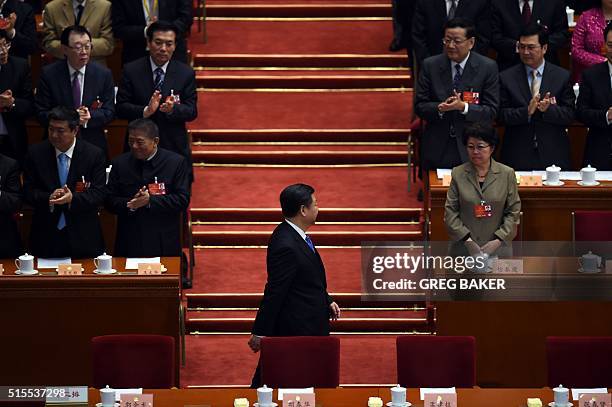 Chinese President Xi Jinping arrives for the closing session of the Chinese People's Political Consultative Conference at the Great Hall of the...