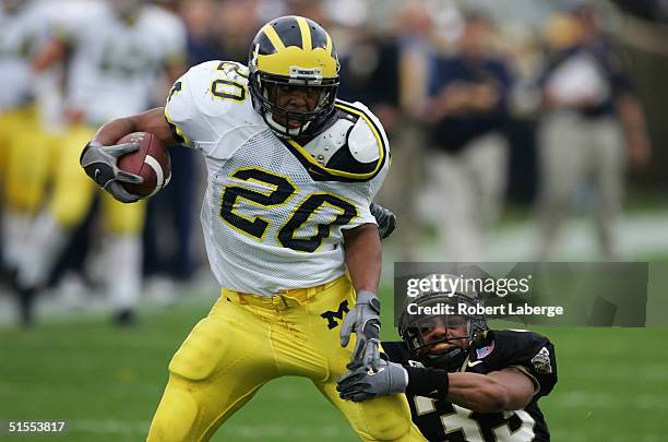 Michael Hart of the Michigan University Wolverines gets tackled by Brian Hickman of the Purdue University Boilermakers during the first half of the...