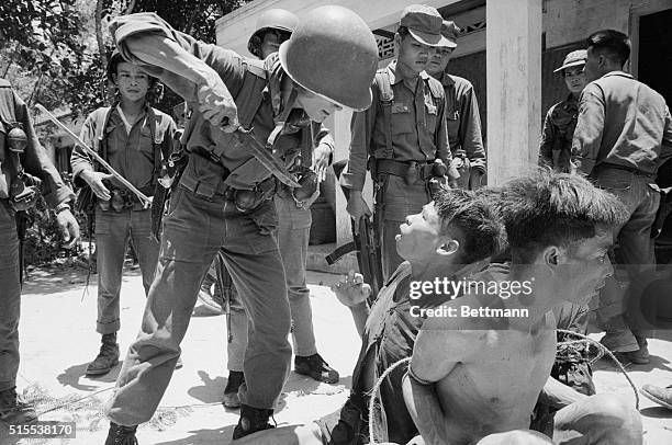 Vietnamese soldier threatens a Viet Cong prisoner with a knife in an effort to force him to reveal the whereabouts of his unit. Twenty Viet Cong were...
