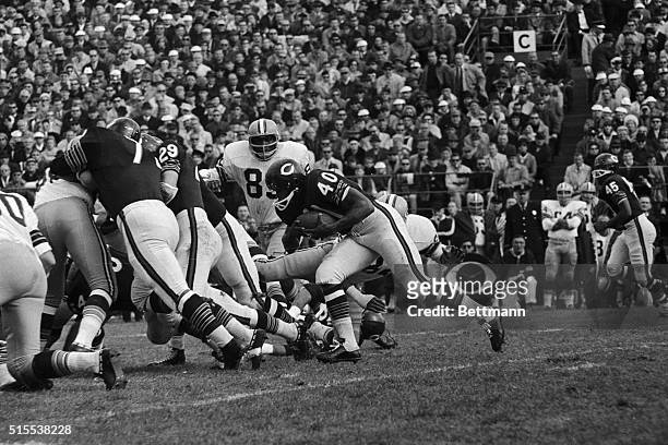 Chicago Bears' Halfback Gale sayers plunges through the line for a 4-yard gain in the first quarter of the game with the Green Bay Packers. Bears'...