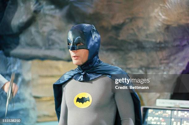 Adam West at Batman in costume during filming of one of the shows.