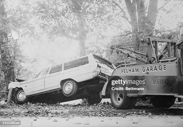 Newport, R.I.: Tow truck prepares to haul away station wagon driven by Doris Duke which fatally crashed Eduardo Tirella. Newport Police Chief Joseph...