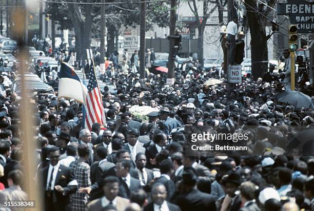 Thousands of funeral marchers gathered outside Ebenezer Baptist Church prepare to walk five miles to Morehouse College where another service for the...