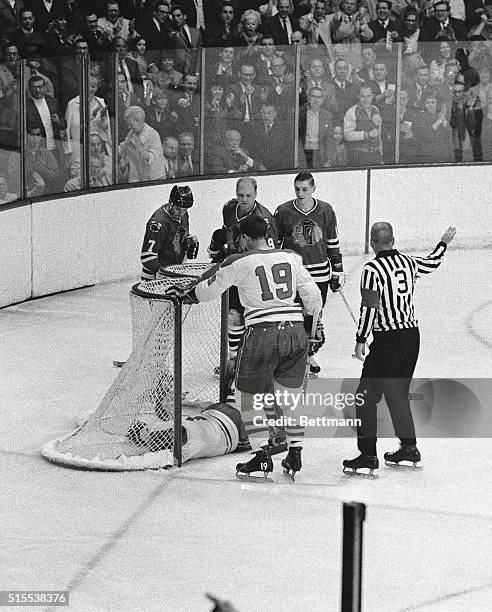 Montreal goalie Gump Worsley lies unconscious in the net after colliding with Black Hawks' Bobby Hull , who scored. Worsley hit his head on the net...