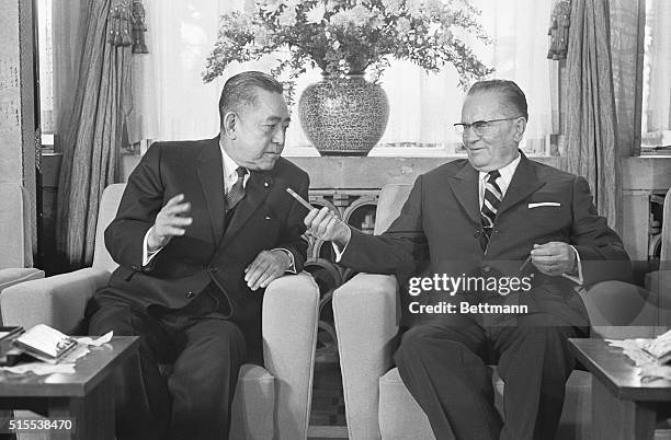 Yugoslav President Josip Broz Tito, right, offers Japan's Prime Minister Eisaku Sato a chair as they begin a conference at Sato's official residence...