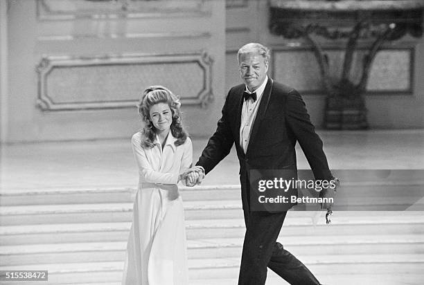Happy. Santa Monica, Calif.: Patty Duke warmly clutches the hand of George Kennedy after he received an Oscar for Best Supporting actor at the...