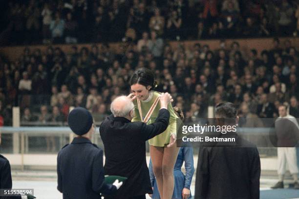 At the 1968 Winter Olympics in Grenoble, France, Peggy Fleming receives her Olympic gold medal for ladies figure skating from Avery Brundage,...