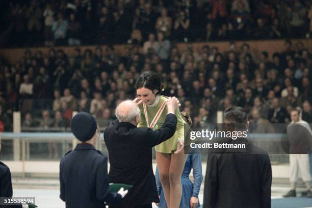 At the 1968 Winter Olympics in Grenoble, France, Peggy Fleming receives her Olympic gold medal for ladies figure skating from Avery Brundage,...