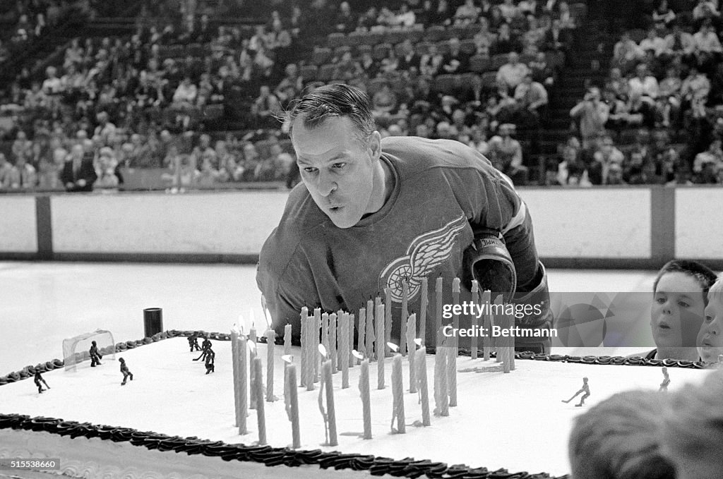 Gordie Howe Blowing Out Candles on Birthday Cake