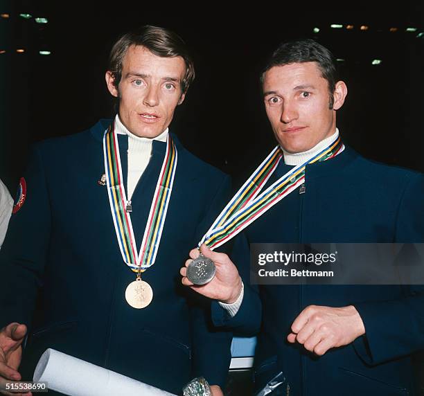 Guy Perillat, Silver medal winner in the Olympic Men's Downhill race and Gold medal winner teammate Jean-Claude Killy of France are both shown with...