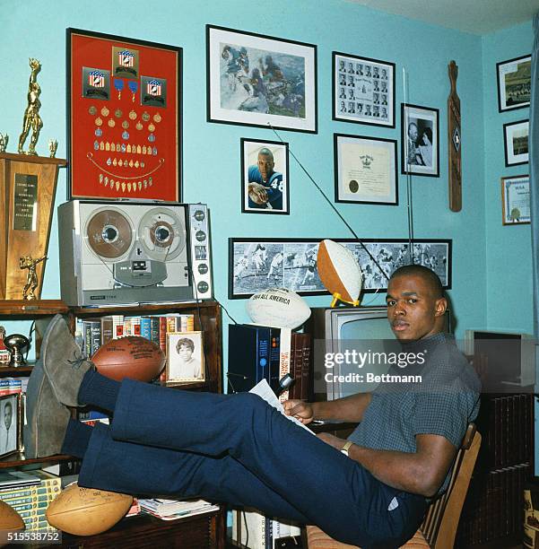 S overwhelming choice for NFL Rookie of the Year, Chicago Bear's Gale Sayers relaxes at home. Sayers won scoring honors with 22 touchdowns as he...