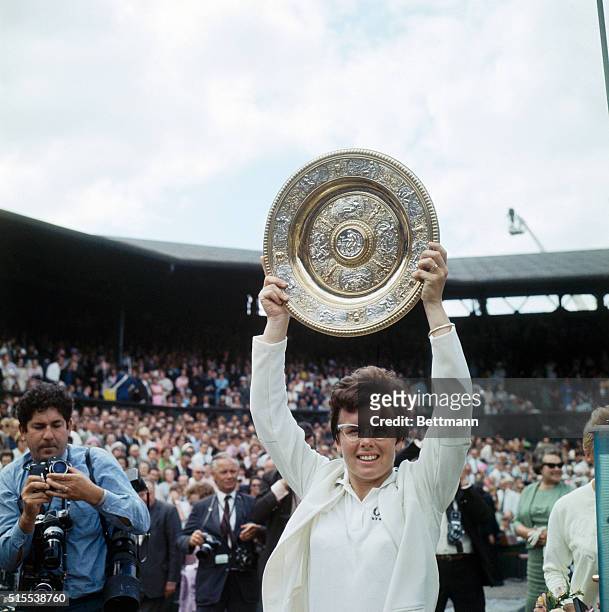 Billie Jean King of the United States holds up the Wimbledon trophy during the awards ceremony following her victory over P.F. Jones for the Women's...
