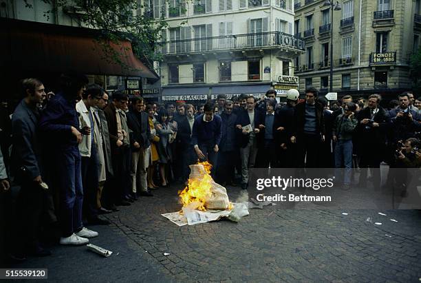 Paris, France: Students watch a bonfire which they started on the Rue Gay Lussac after a night of fighting in the Latin Quarter. Pres. DeGaulle, his...