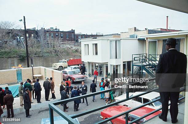 Man stands on balcony of Lorraine Hotel in the approximate place Martin Luther King, Jr., stood when he was killed April 4th. In the background is...