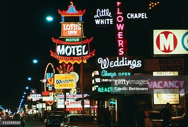 This is a general view of a Wedding Chapel sign in foreground, as well as motels, restaurants, etc., along Las Vegas boulevard. The marriage business...