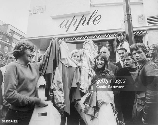 Shouting, gesticulating London police mingle with newsmen and eager, would-be "customers" July 31st outside the Beatles' Baker Street boutique,...