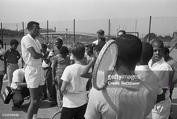 Arthur Ashe, the Nation's second-ranked amateur, talks to a group of Washington youngsters during one of eight area tennis clinics here. Bobby Lutz,...