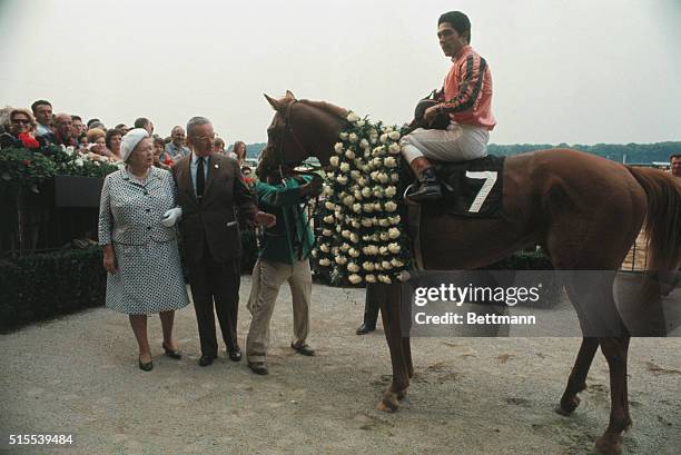 New York: Jockey Heliodoro Gustines on top Stage Door Johnny are shown in the winners circle after they won the Belmont Stakes. Also shown are the...