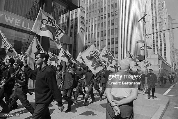 Banner carrying members of the militant Black Panther Party march here on 42nd Street en route to a scheduled news conference at United Nations...