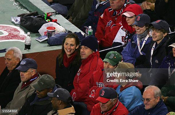 Actors Ben Affleck and Jennifer Garner sit together while they watch the Boston Red Sox take on the St. Louis Cardinals during game one of the World...
