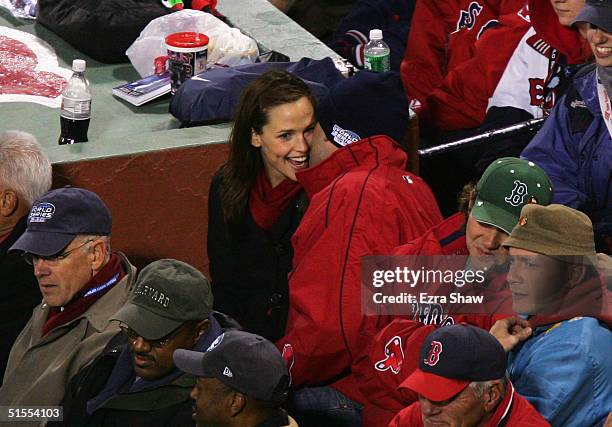 Actors Ben Affleck and Jennifer Garner sit together while they watch the Boston Red Sox take on the St. Louis Cardinals during game one of the World...