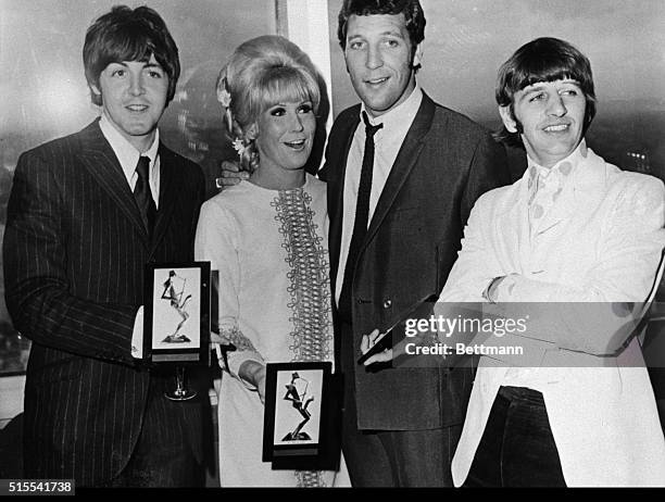 Holding their awards at the Post Office Tower in London, is Beatle Paul McCartney; singer Dusty Springfield; singer Tom Jones; and Beatle Ringo Starr.