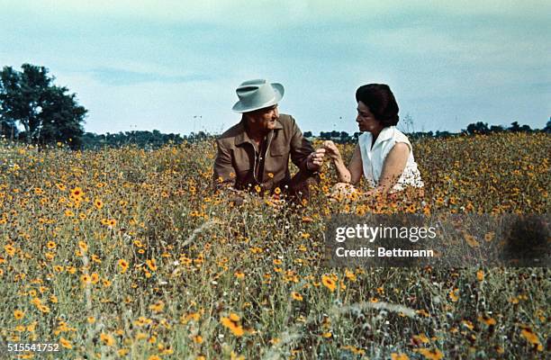 President Lyndon B. Johnson and Lady Bird Johnson are shown here in informal and relaxing attire at the LBJ Ranch.