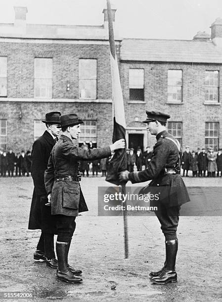 Minister of Defence Mr. Mulcahy, formerly Chief of Staff, presenting the Republican colors to Captain O'Daly. Standing at the back of Mulcahy in...