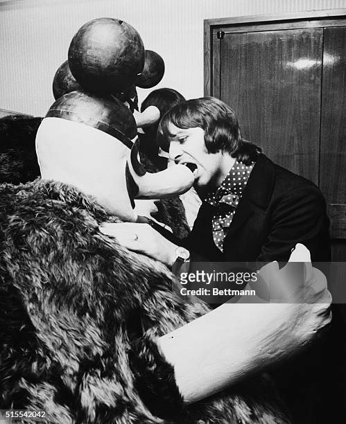Beatle Ringo Starr bites the nose of a Blue Meanie at a press conference, July 8th, for Yellow Submarine, a Beatle full length animated film. Blue...