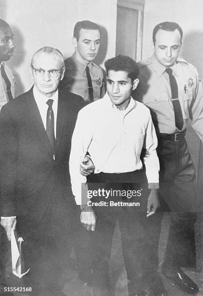 Full length view of Sirhan B. Sirhan, accompanied by his Attorney Rusell E. Parsons and deputy sheriffs, Sirhan, the accused in the Robert F. Kennedy...